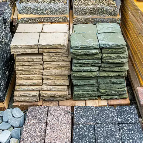 stacks of paver stone options at a landscape supply company