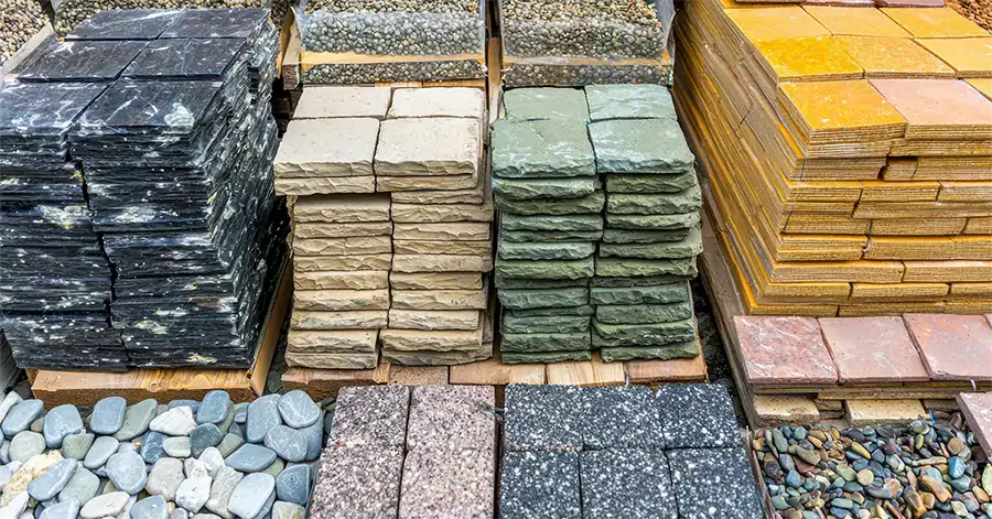 stacks of paver stone options at a landscape supply company