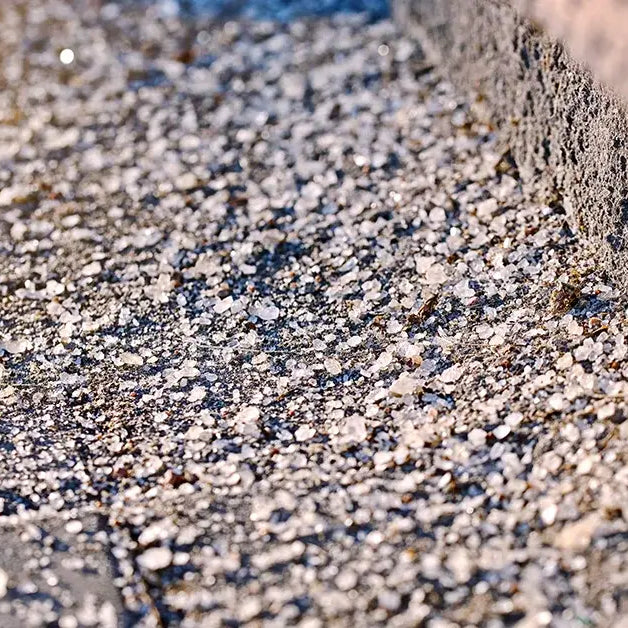 Ice melts sits on a walkway