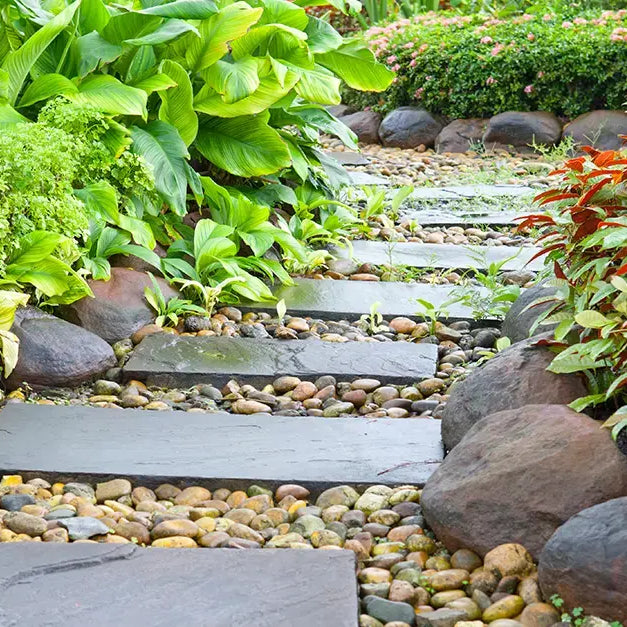 stepping stones line this walkway with gravel filling the space between them.