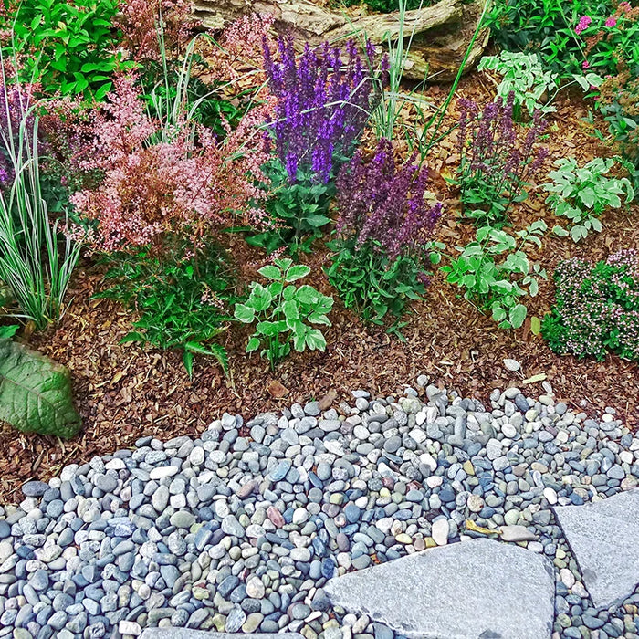 flower garden with mulch and decorative stones