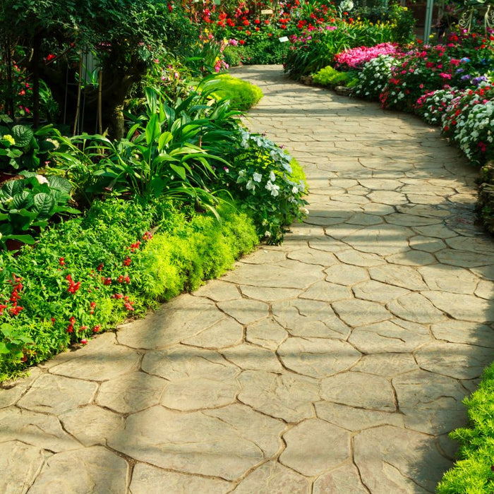 A path made of pavers in a green, vibrant garden