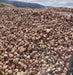Heap of multicolored stones with a mountainous landscape in the background