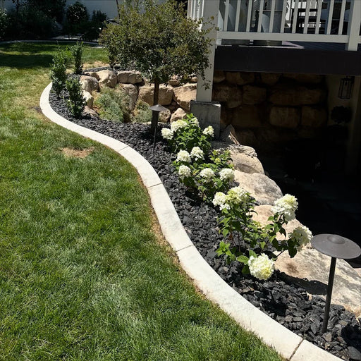 crushed basalt rock in a flower bed with hydrangeas