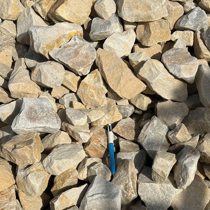 2-4" gold rush crush rock with a pen to show scale