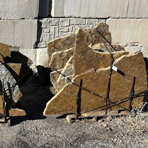 Large stone slabs on a construction site with a wall in the background