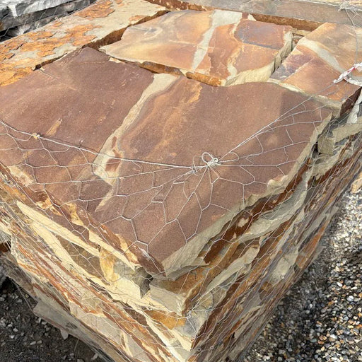 Close-up of a stone wall with brown and beige stones