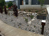 Gunsmoke landscape rock in a front yard installation