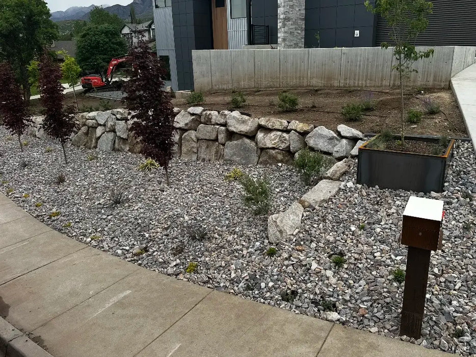 Gunsmoke landscape rock in a front yard installation